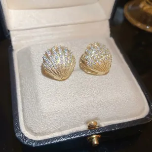 Elegant gold-plated seashell stud earrings with micro-paved zircons in a premium gift box