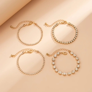 Detailed view of 4-piece gold bracelet set with rhinestones and lobster clasp closures