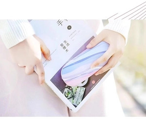 Chic pastel marble-patterned eyeglass case held by a person for a lifestyle showcase
