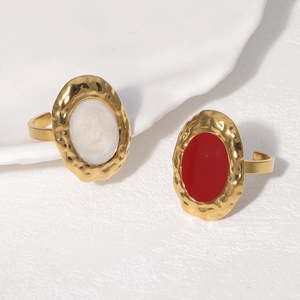 Detail of vintage gold rings with hammered texture and colorful oval resin inlays