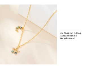 Detail of gold star and moon necklace featuring sparkling 5A blue and white zircon flowers
