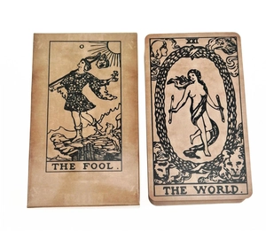 Close-up of The Fool and The World oracle cards on vintage brown kraft paper stock