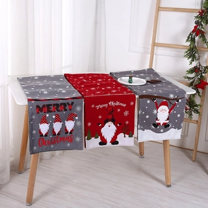 Detail of Christmas table runner with knitted gnome embroidery and Merry Christmas text