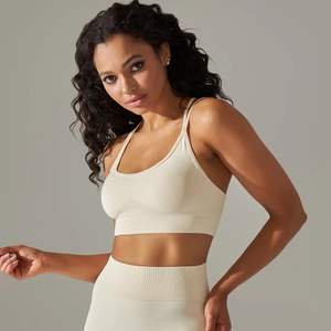 Detail of beige seamless knitted ribbed sports bra and leggings with high elasticity