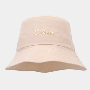 Close-up of beige quick-dry bucket hat with embroidered Smile text and face