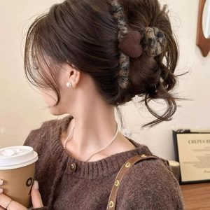 Elegant dark brown velvet heart hair claw clip for women styled in a French updo