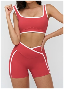 Detail view of square neck sports bra with contrast piping and V-waist yoga shorts