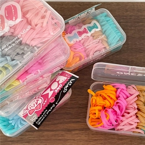 Set of four boxes of colorful elastic hair bands for girls in pastel cream colors
