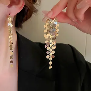 Chic gold metallic sequin fringe drop earrings featuring layered waterfall tassel design
