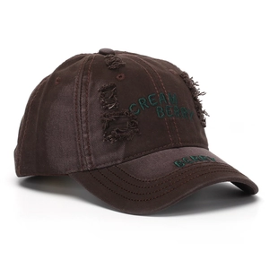 Detail of distressed dark coffee cotton baseball cap with green Cream Berry embroidery
