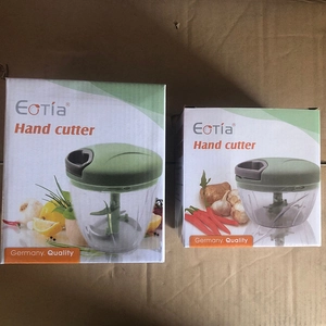 Packaging view showing two sizes of green manual hand cutters on cardboard background