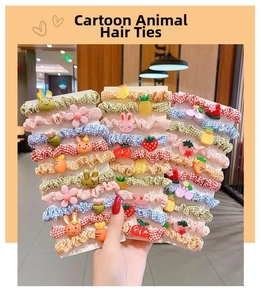 Close-up of cute cartoon animal and fruit hair scrunchies set with floral fabric textures