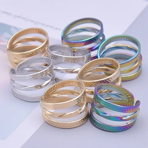 Stack of multi-layer spiral stainless steel rings in gold, silver and rainbow colors