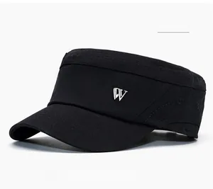 Detail of black cotton sun visor with metal letter W logo and stitch brim texture