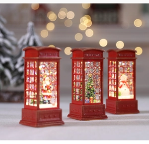 Three red Christmas telephone booth lanterns with Santa, snowman and tree scenes