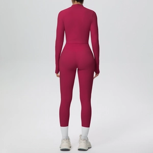 Back view of high-waist seamless yoga leggings and long sleeve cropped top in deep berry red