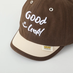 Kids' baseball cap in brown and beige with Good Luck embroidery and a smiley face design