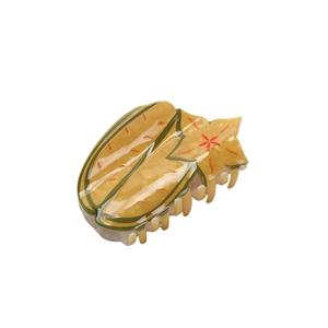 Starfruit shaped hair claw clip in yellow and green plastic for summer hairstyling