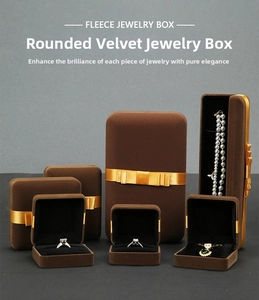 Detailed view of coffee velvet jewelry boxes with elegant gold ribbons and bows