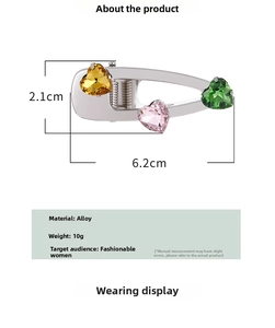 Detail view of heart-shaped hair clip with dimensions 6.2cm x 2.1cm and colorful crystals