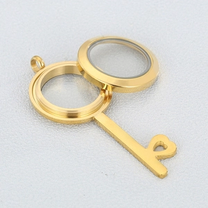 Golden stainless steel locket key pendant with heart-shaped cutout on a gray texture