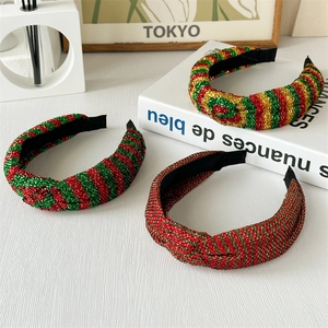 Close-up of red, green, and gold glitter stripe knotted headbands for Christmas styling