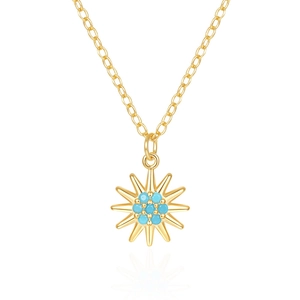 Detailed macro view of sunburst gold pendant with inlaid turquoise gemstone flowers