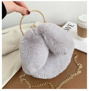 Detail showing the metal ring handle and plush grey texture of this fashion handbag