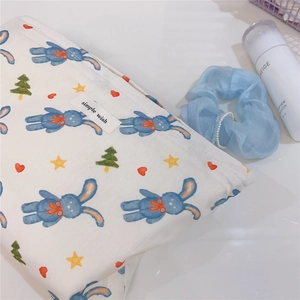 Close-up of cotton canvas pouch with rabbit print, zipper closure and branded label