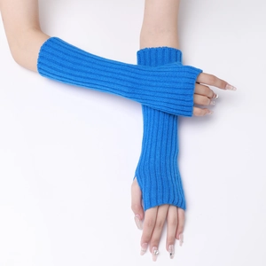 Close-up of blue knitted long fingerless gloves with ribbed texture on model arms