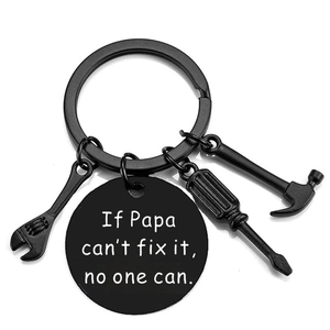Detail of black metal keychain with hammer, wrench, screwdriver charms and Papa quote