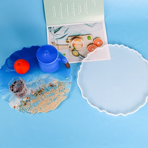 Detail of DIY epoxy resin wave tray mold with ocean style finished product and sand decor