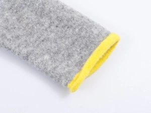 Close-up of contrast grey wool knit sleeve with bright yellow ribbed edge detail