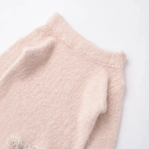 Pink knit sweater with soft fluffy texture and white floral lace hem detail