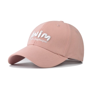 Close-up of pink washed cotton baseball cap with white 3D embroidery detail
