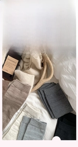 Close-up of knit cotton socks in neutral earth tones showcasing soft ribbed texture