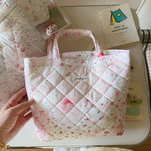 Detail of pink floral quilted tote bag featuring a 'Simple Wish' tag and soft cotton texture