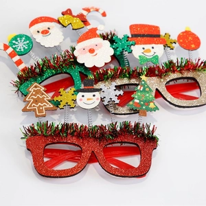Detail of Christmas glasses frames with glitter finish and colorful festive tinsel trim