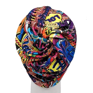 Detail of colorful graffiti print and twisted knot design on this hip-hop style beanie hat