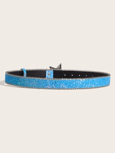 Detail shot of blue sequin belt with metallic star buckle against a beige backdrop