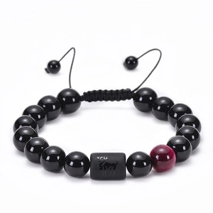 Detailed macro view of adjustable Aries zodiac bracelet with 10mm black beads