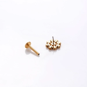 G23 titanium labret piercing jewelry featuring gold snowflake stud and push-pin bar