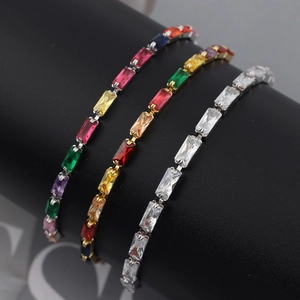 Detailed view of rectangular cut colorful zircon tennis bracelets on a black display stand