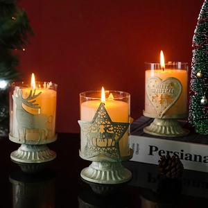 Three-piece Christmas glass candle holders with metal reindeer and star cutouts in red theme