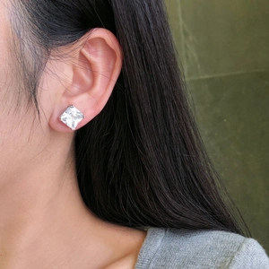 Close-up of S925 sterling silver stud earring with large square zircon on model ear