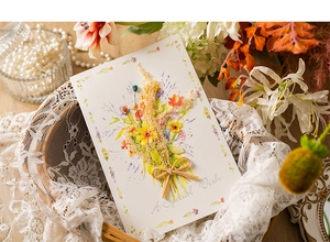 Detail of handmade greeting card with dried flowers and "A Special Wish" script text