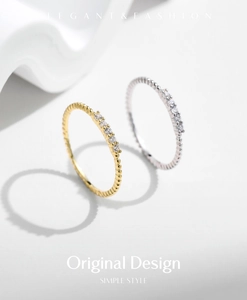 Detailed view of elegant gold and silver beaded rings with sparkling round gemstones