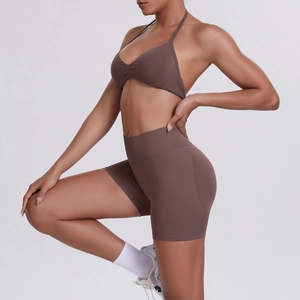 Detail view of seamless chocolate sports set featuring halter neck top and high waist shorts