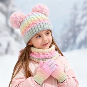 Close-up of kids rainbow gradient knit hat with double pom-poms and matching scarf