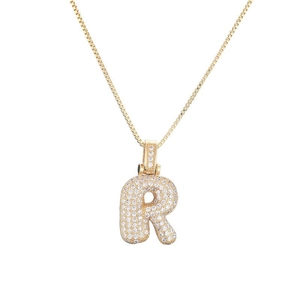 Detail of letter R pendant featuring micro-pave cubic zirconia and gold box chain